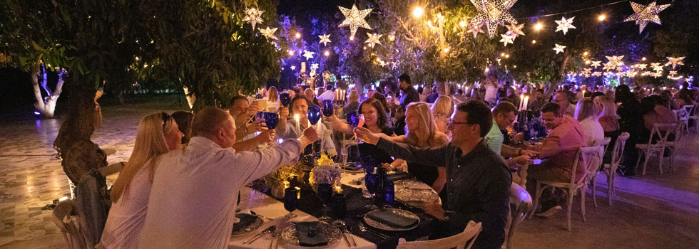 happy incentive travel winners dine along beachfront